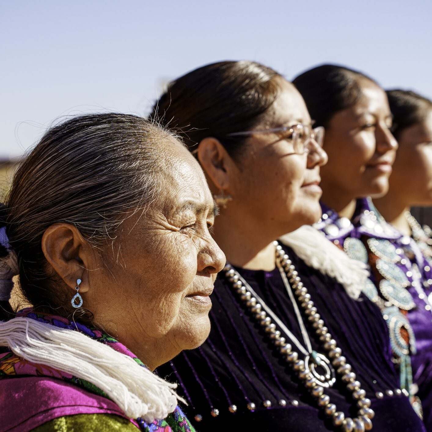 Shallow Depth of Field Profile Portrait of Traditionally Dressed Navajo Women of Three Generations on a Sunny Morning in Monument Valley Utah Arizona