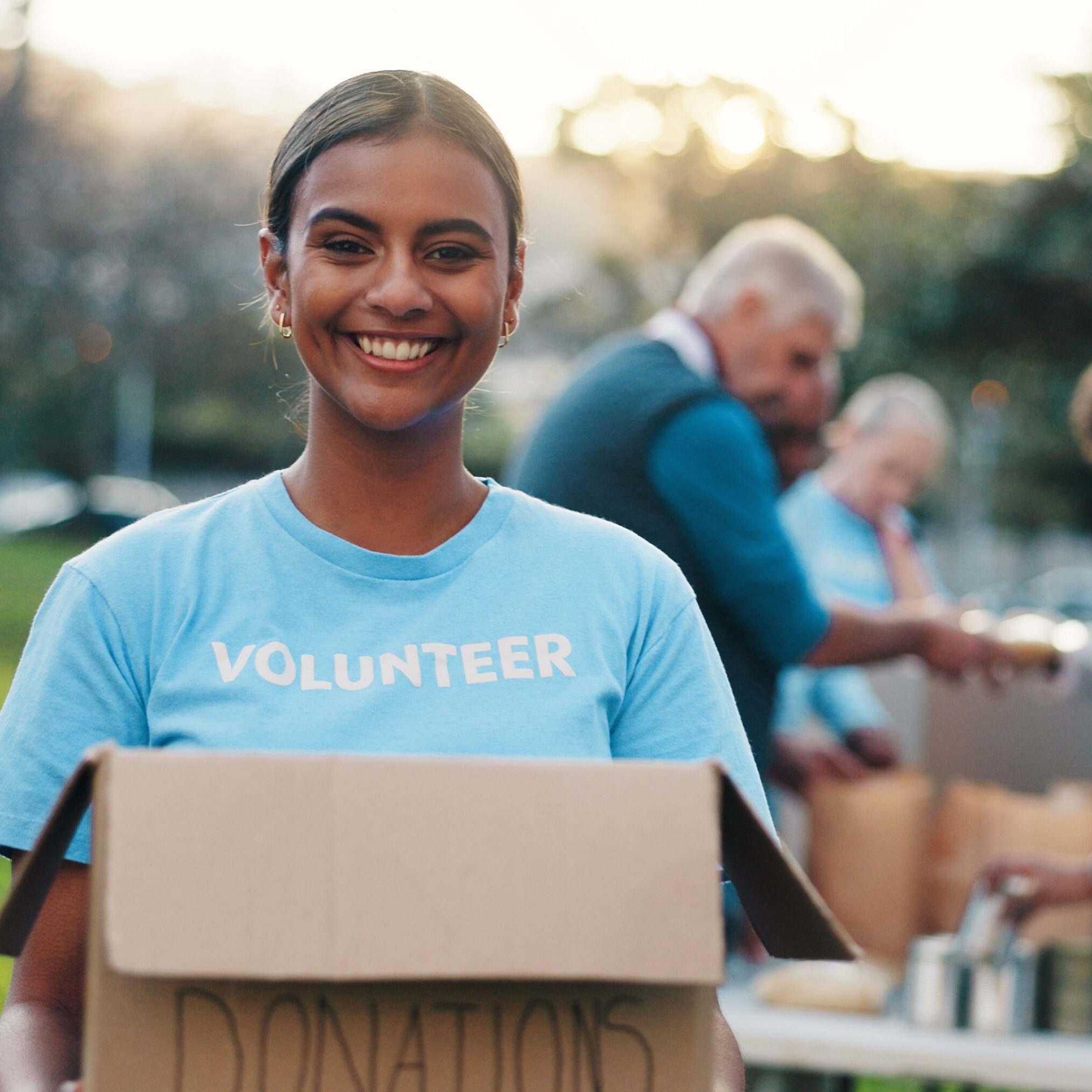 Volunteer, outdoor and portrait of woman with box for food drive, charity event and donation. Help, teamwork and people with package for outreach program, community service and nonprofit in park